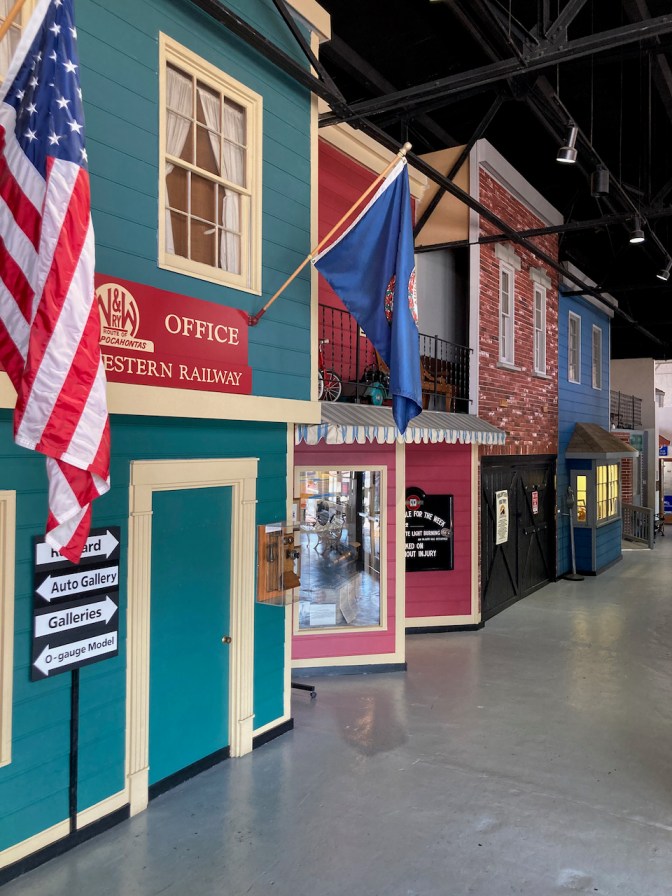 Facades of buildings representing street, inside of museum.