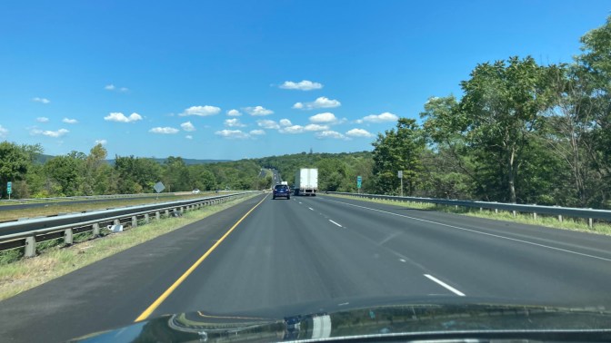 View of NY Thruway on sunny day with blue skies.