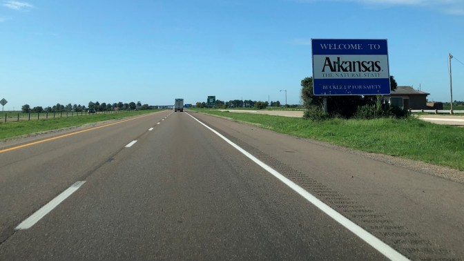 Welcome to Arkansas sign along highway.