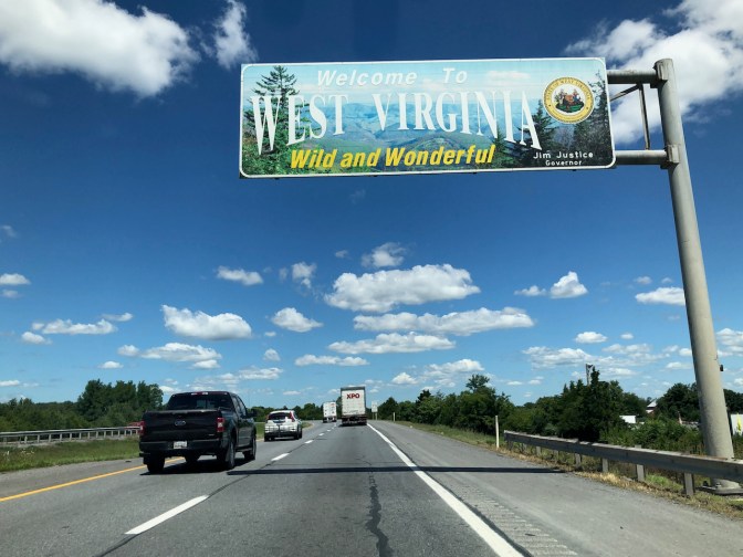 Interstate highway with WELCOME TO VIRGINIA sign over road.