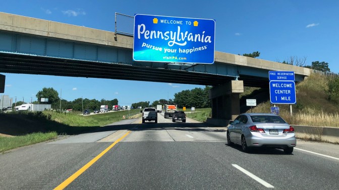 Interstate highway with WELCOME TO PENNSYLVANIA sign over road.