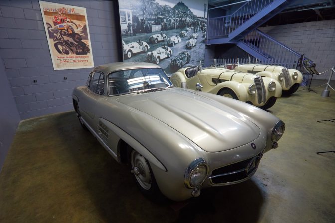 Mercedes-Benz 300SL in front of Nurburgring exhibit.