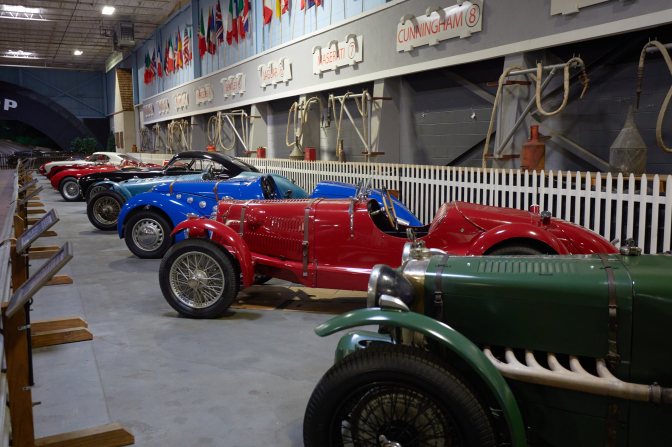 Cars on display in replica of Le Mans pit lane.