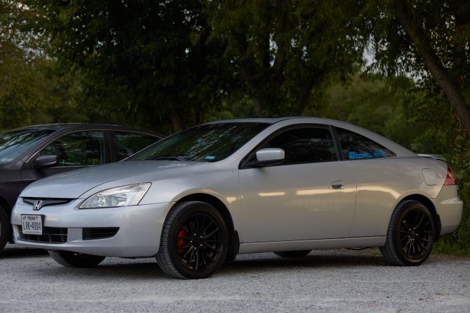 2003 Honda Accord coupe in silver, parked in gravel lot.