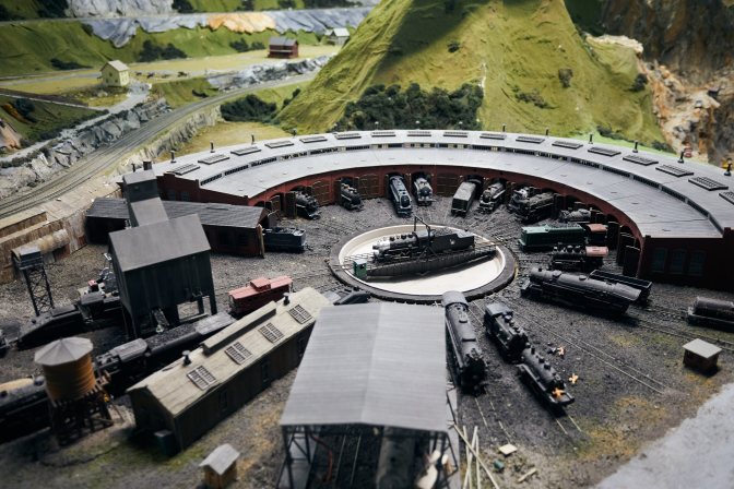 Model railroad turntable in train yard.