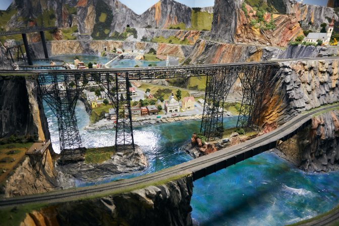 Two railroad bridges running in front of model town.