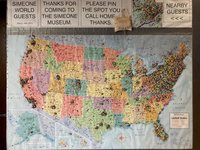Map of United States with push pins in locations of visitors.