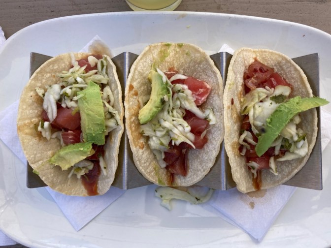 Three tacos on plate.