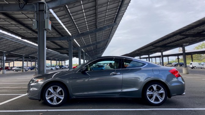 2012 Honda Accord in parking lot with solar panels above car.