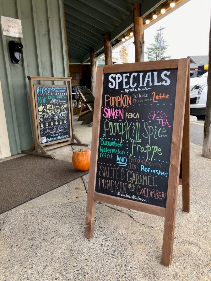 Blackboard sign outside of coffee shop that lists specials of the day.