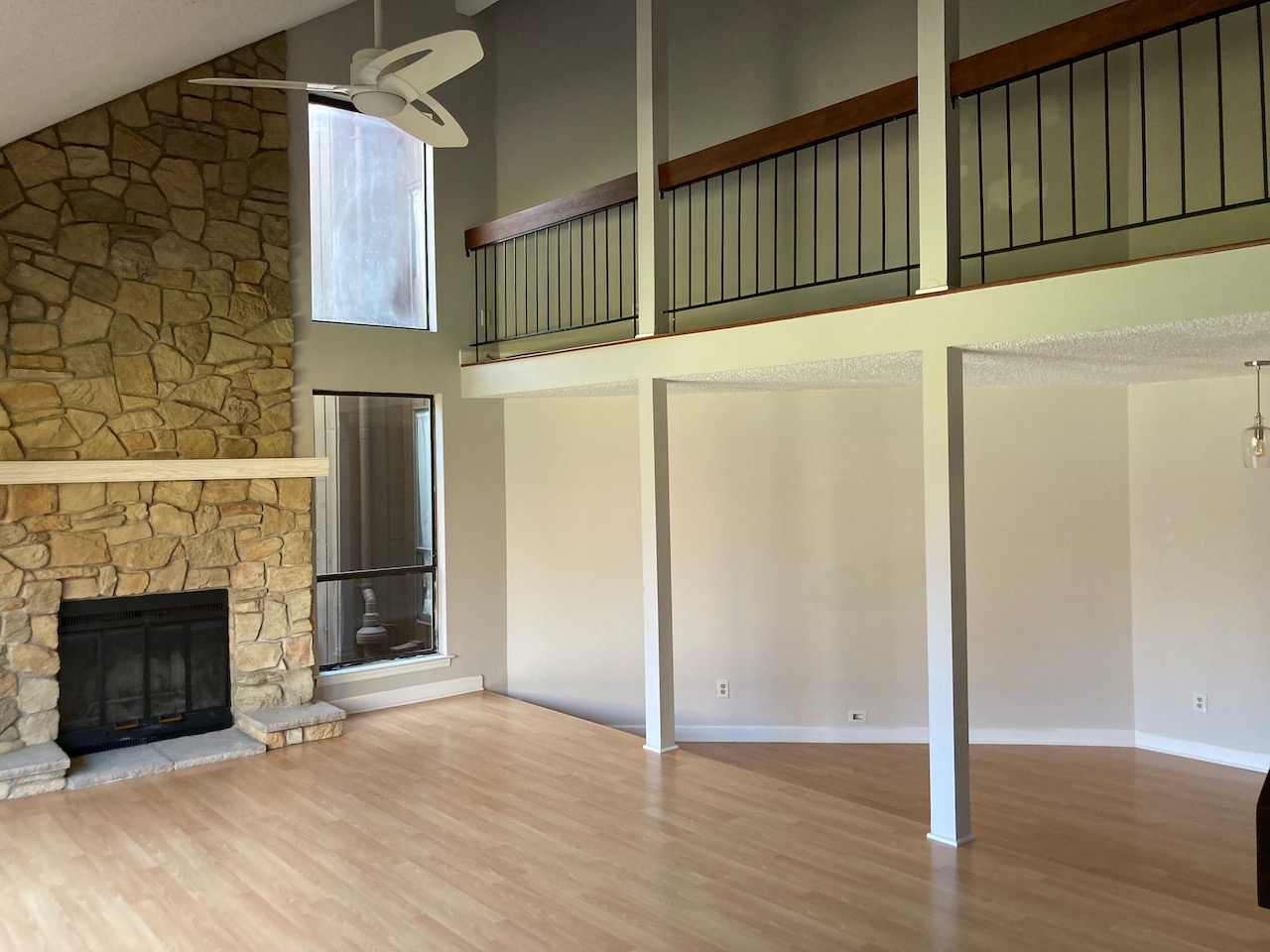 Empty living room and upstairs loft area of home.