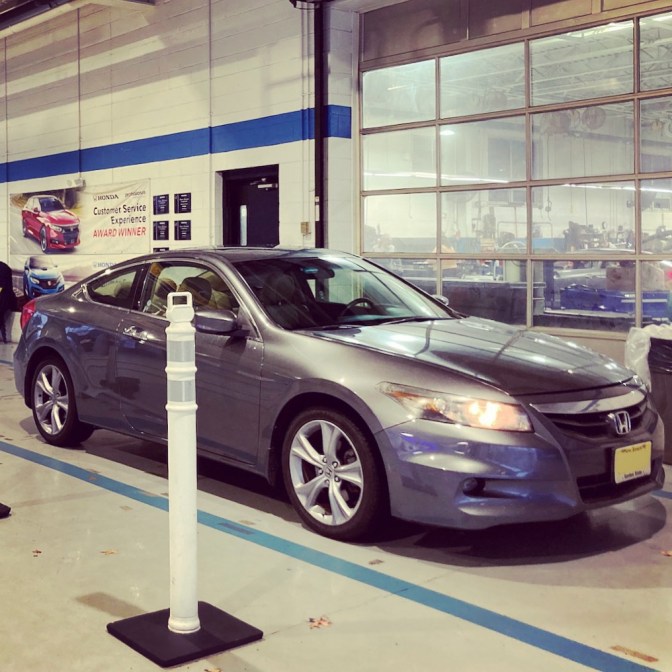 2012 Honda Accord coupe in dealership service drive.