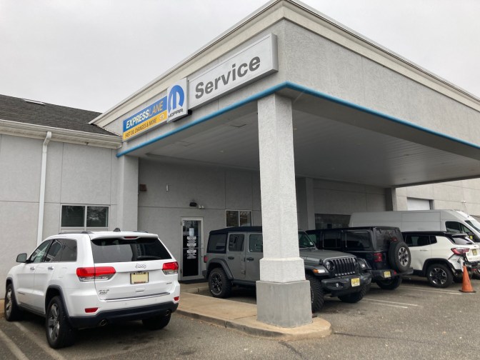 Jeep Grand Cherokee parked in dealership service lot.