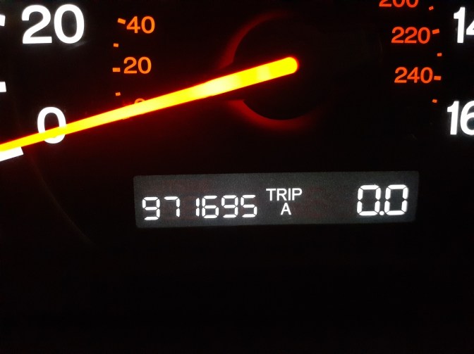 Car odometer reading 971695 miles.