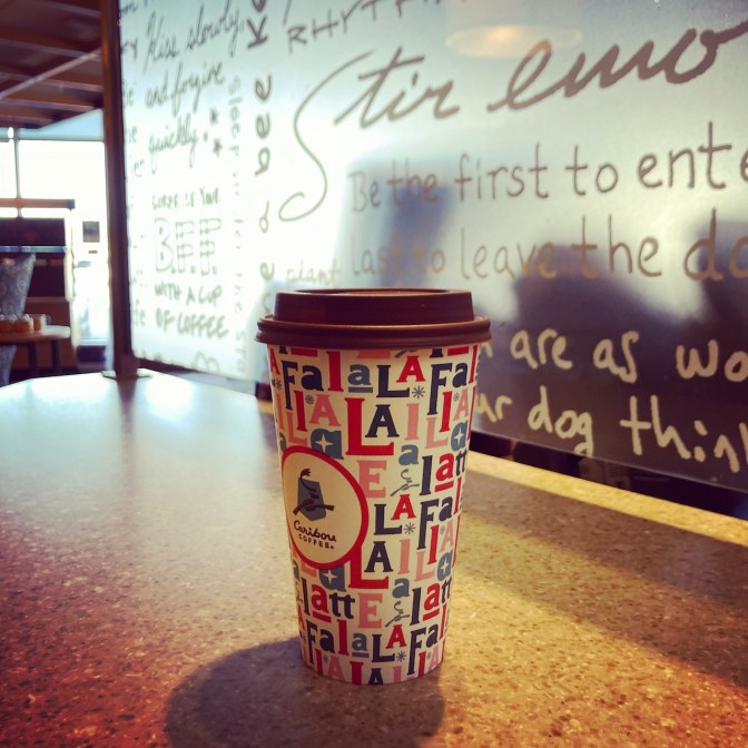 Coffee cup on counter at coffee shop.