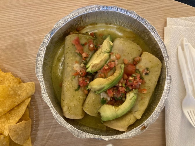 Carnitas enchiladas in aluminum foil dish.