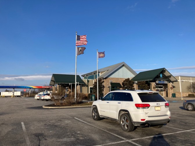 2014 Jeep Grand Cherokee parked outside rest stop.