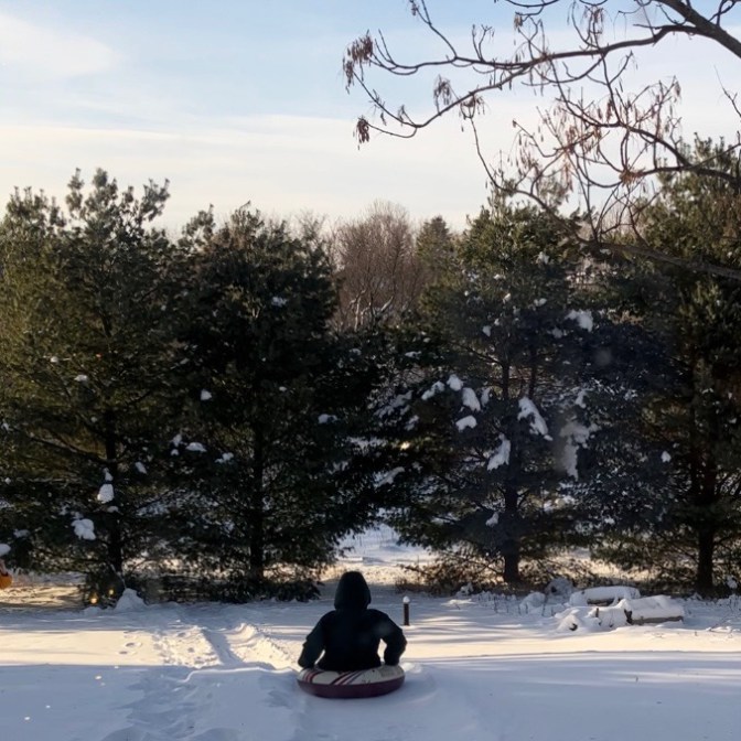 Man sledding down hill.
