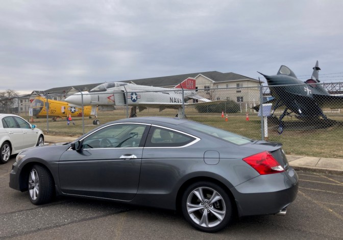 2012 Honda Accord parked in front of fence, with F-4 Phantom, Sea Dart, and Retriever in background.