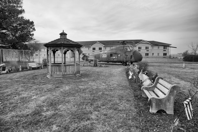 Small memorial garden with gazebo. A Sikorsky UH-34D helicopter is in the background.