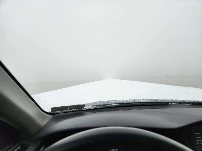 Snow-covered road through Bonneville Salt Flats.