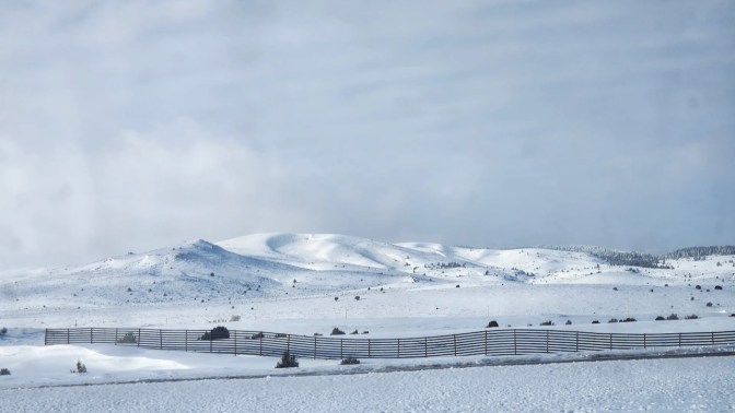 Hills and fields covered in snow.