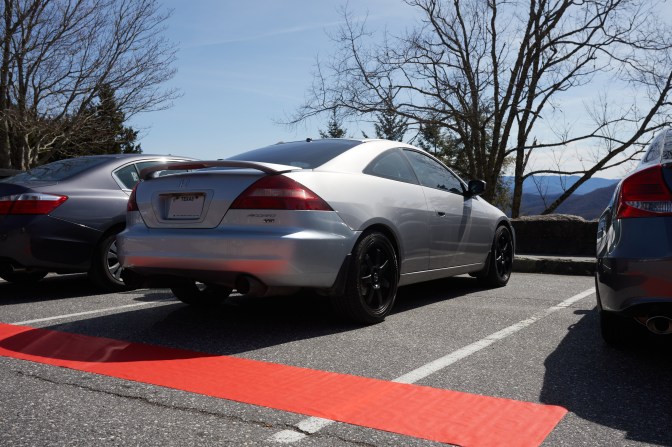 2003 Honda Accord in parking spot, with red carpet in foreground.