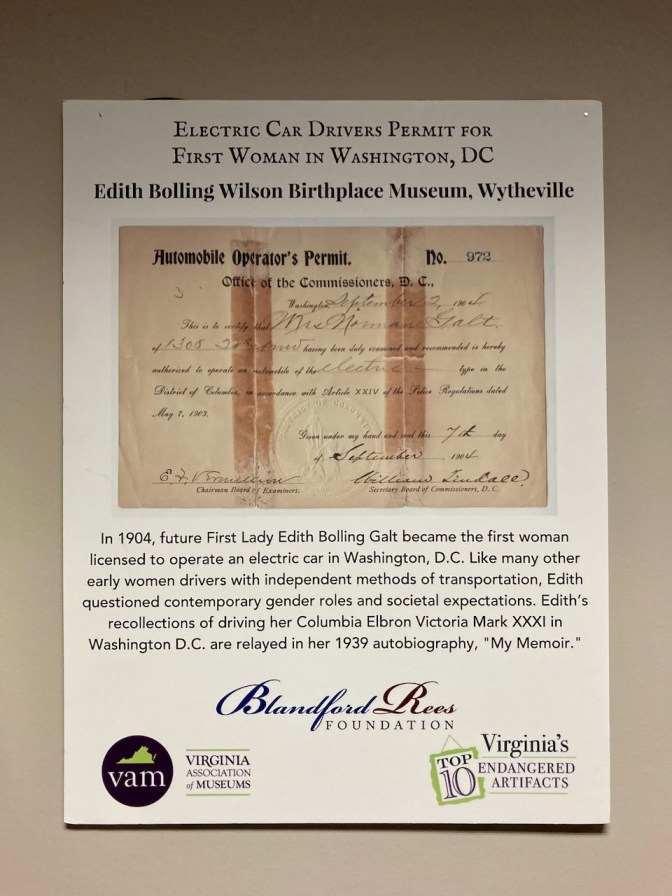Placard with display of Edith Wilson's electric car license.
