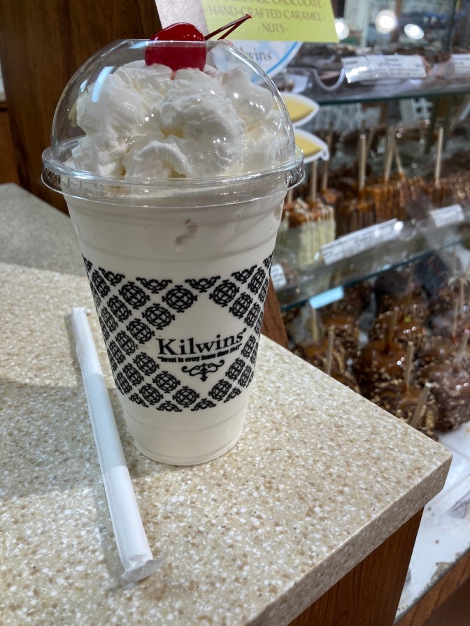 Vanilla milkshake in Kilwin's plastic cup.