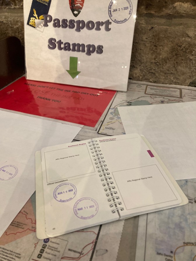 National Park Passport book, open with stamped pages.