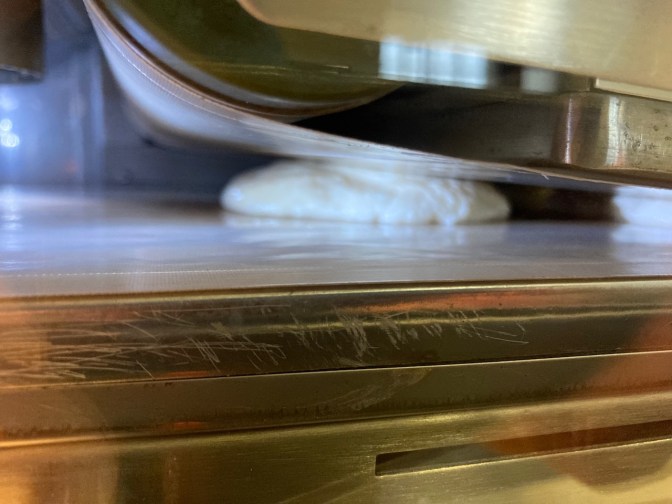 Pancake on convey belt in machine.