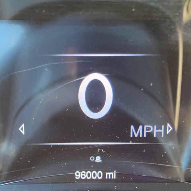 Car odometer reading 96000 miles.