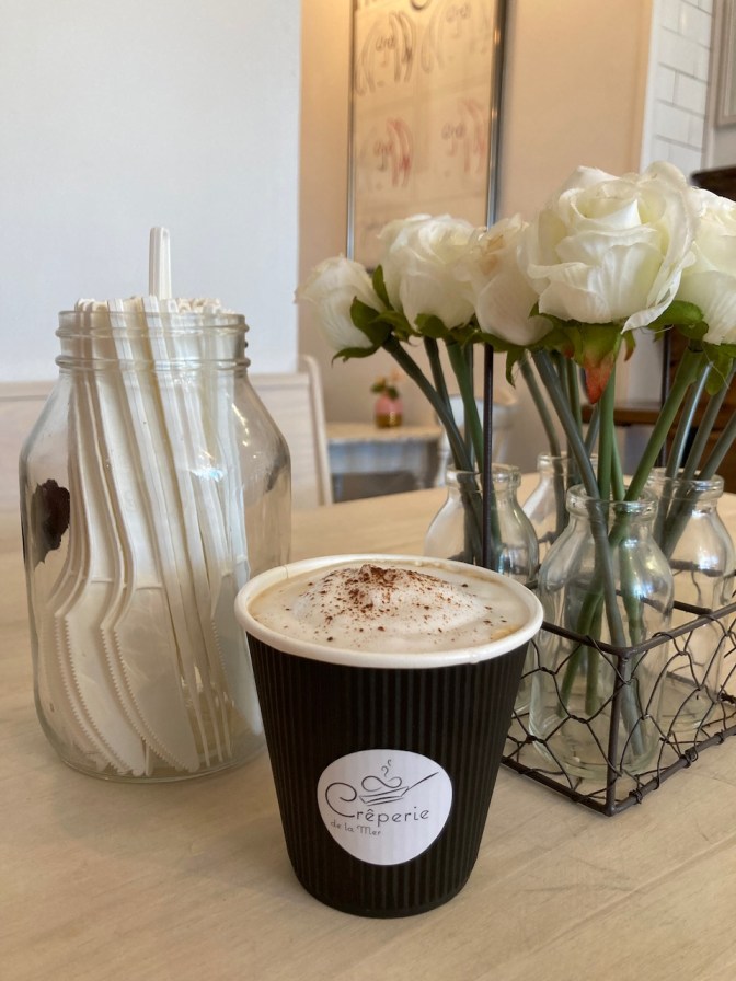 Cappuccino in paper cup.