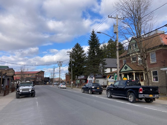 Downtown Old Forge, with a few cars on side of road.