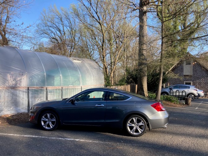 2012 Honda Accord parked beside greenhouse.
