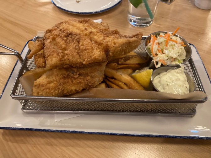 Fish and chips in wire basket.
