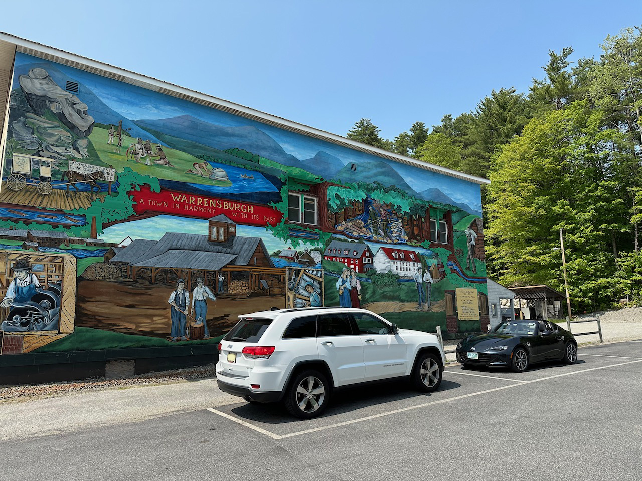 2014 Jeep Grand Cherokee parked in front of town mural in Warrensburg, NY.