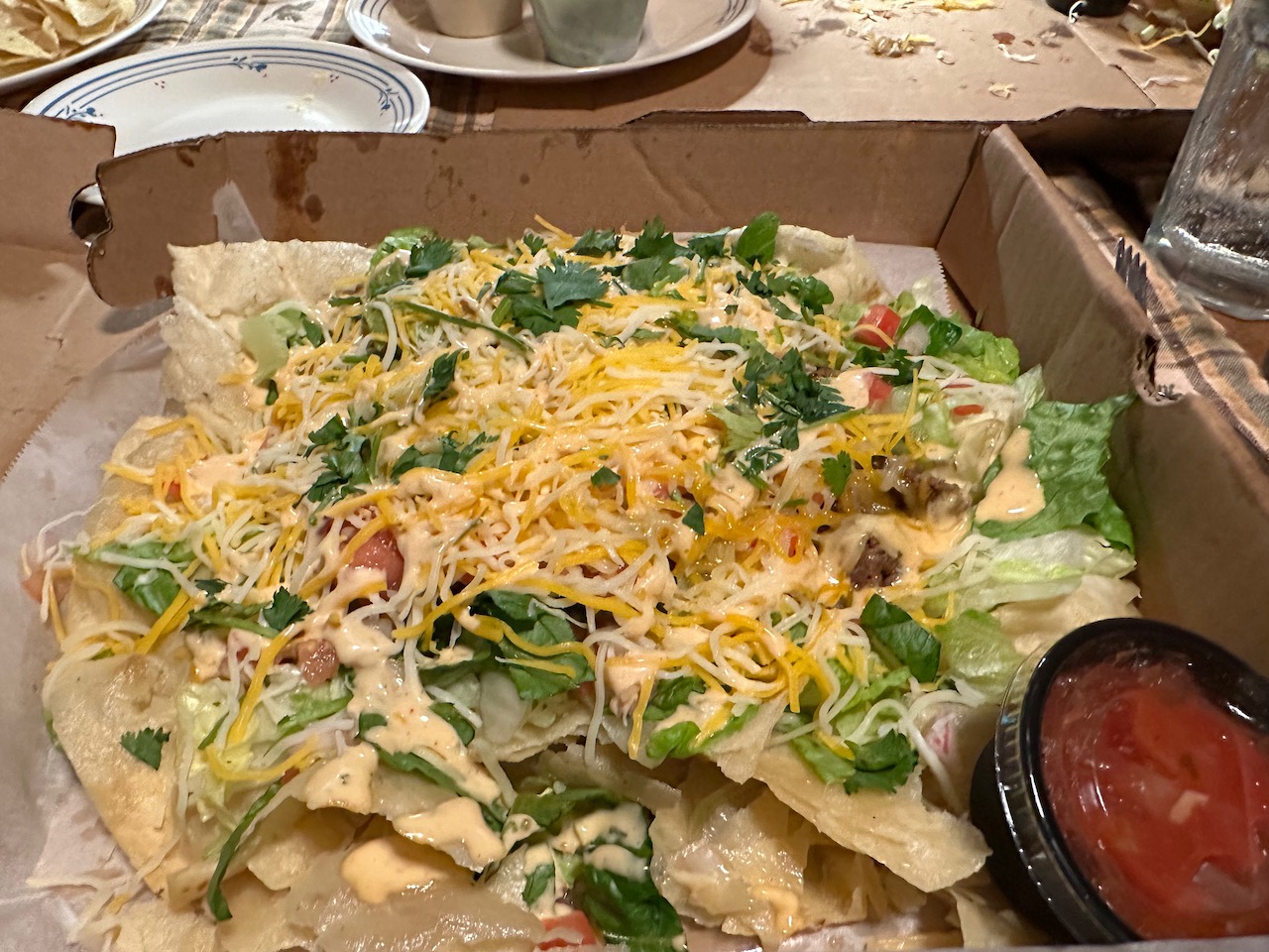 Taco salad in takeout box.