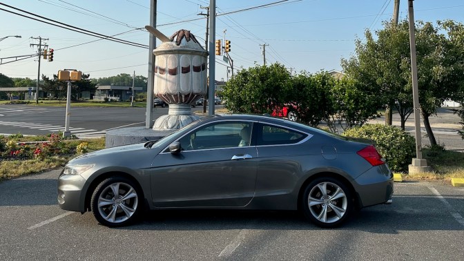 2012 Honda Accord parked in front of statue of ice cream sundae.
