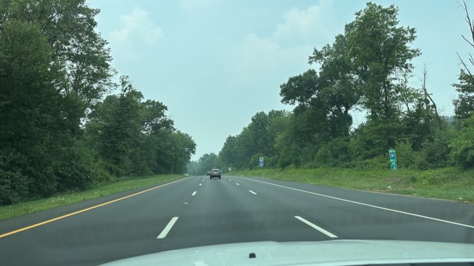 I-287 from behind dashboard of Jeep Grand Cherokee. The sky is cloudy and hazy.