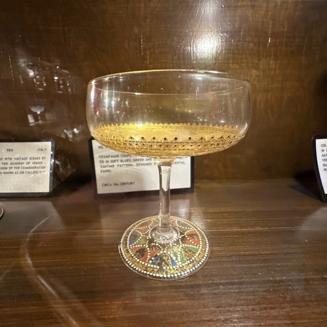 Champagne glass etched with gold.