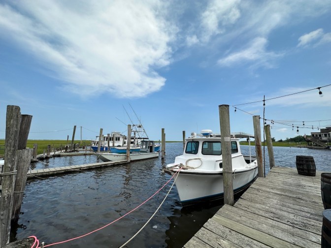 Boats tied up a dockside.