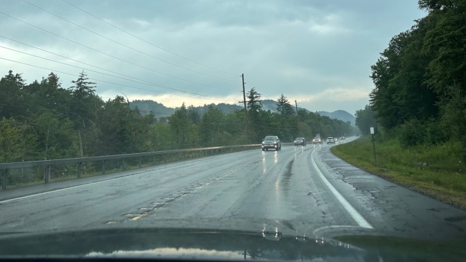 Rain-soaked NY Route 28 in the mountains. Traffic is in opposite lane.