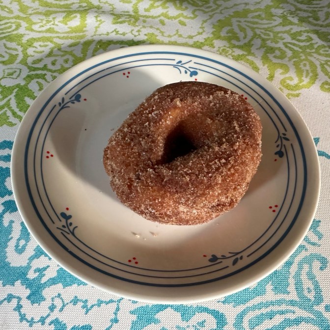Donut on white plate.