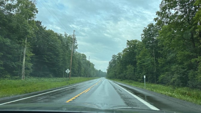 View of rain-soaked NY 28 from behind dashboard of Honda Accord.