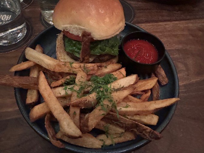 Cheeseburger and fries on plate.