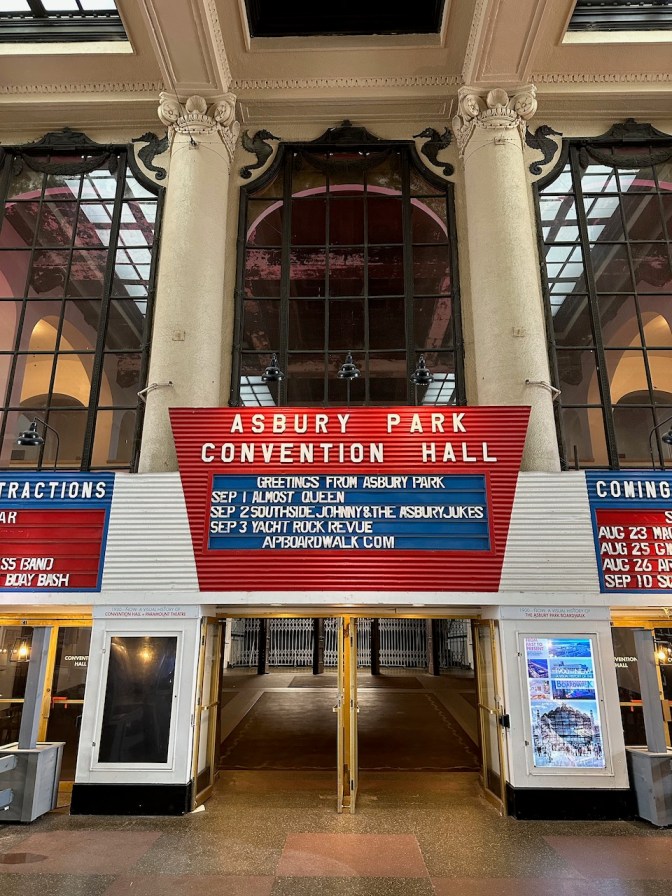 Interior of Asbury Park Convention Hall, with sign of upcoming acts.