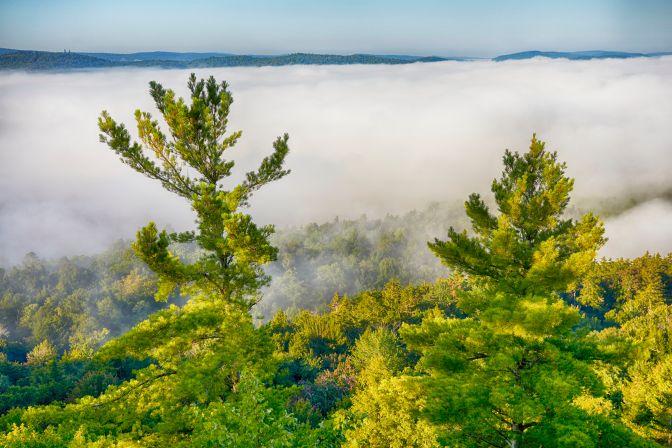 View of cloud inversion over ground below mountain.