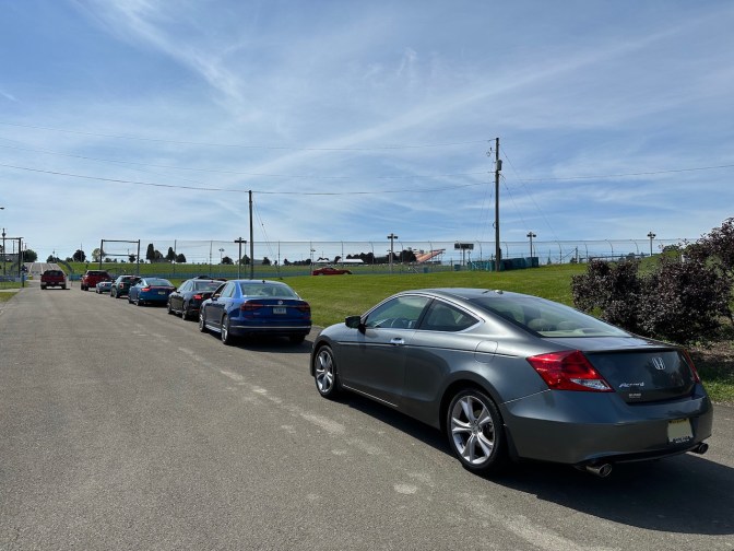 2012 Honda Accord in lineup of vehicles waiting to go onto race track.