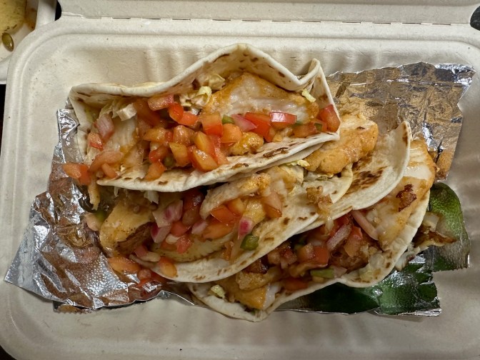 Fish tacos in to-go container.